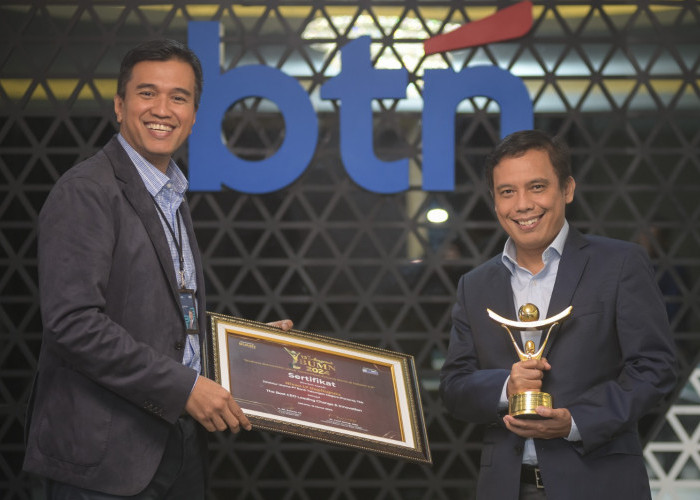 Direktur Utama BTN Nixon LP Napitupulu didampingi Corporate Secretary BTN Ramon Armando memperlihatkan tropi dan sertifikat penghargaan The Best CEO Leading Change Innovation di Jakarta, Kamis (14/3).
